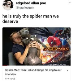 a man holding a dog in front of a spider - man movie poster with his face close to the camera