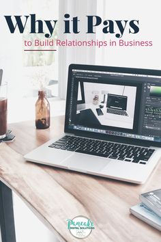 a laptop computer sitting on top of a wooden desk next to a cup of coffee