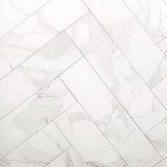 a white marble tile floor that looks like herringbones