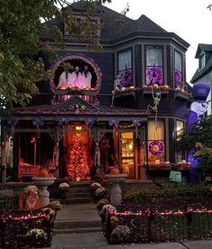 a house decorated for halloween with lights and decorations