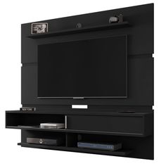 an entertainment center with a flat screen tv mounted on it's side and shelves