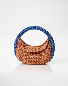 - 100% Handmade - Copper/Blue - Measurements L:30cm x H:17cm x W:8cm - Hand-crocheted top round handle - Secures with magnetic closure - Comes with dust bag to always keep your Miss Polyplexi bag well-protected and clean The Miss Polyplexi Normandy Hobo Bag has a cute rounded silhouette. It is handmade in Greece by highly skillful female artisans. Its shinny effect comes from the beautiful and sleek metallic yarn combo of copper and blue colours. This style is elegant and ideal for your evening Natural Bags With Braided Handles, Natural Color Bags With Braided Handles, Brown Pouch Straw Bag With Top Carry Handle, Blue Hobo Tote Bag With Top Carry Handle, Blue Hobo Bag With Top Carry Handle, Blue Baguette Bag With Detachable Handle, Blue Baguette Bag With Detachable Top Handle, Blue Rectangular Baguette Bag For Shopping, Handmade Blue Pouch Shoulder Bag