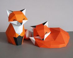 two origami foxes sitting next to each other