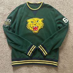 Polo Ralph Lauren Varsity Tigers Logo-Patch Graphic Sweatshirt Mens M. Good Condition Please See Pictures For Wear Green Cotton Tops With Logo Detail, Sporty Crew Top With Logo Patch, Yellow Sporty Sweatshirt With Graphic Print, Sporty Crew-neck Top With Logo Patch, Sporty Yellow Sweatshirt With Graphic Print, Yellow Crew Neck Tops With Embroidered Logo, Green Long Sleeve Top With Embroidered Logo, Casual Yellow Tops With Embroidered Graphics, Yellow Cotton Top With Embroidered Logo