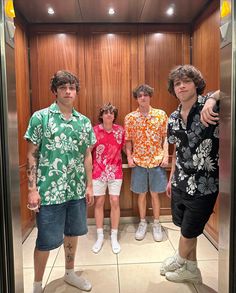 four young men standing in front of an elevator