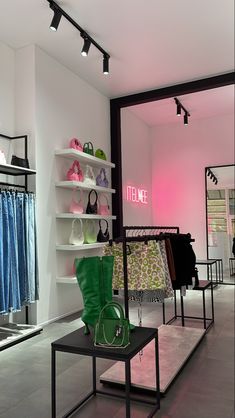 the inside of a clothing store with shoes and handbags