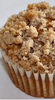 a muffin with crumbs sitting on top of it