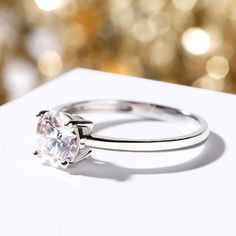 a diamond ring sitting on top of a white box