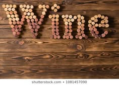 the word wine spelled with corks on a wooden background