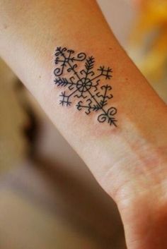 a woman's wrist with a tattoo on it