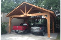 two cars parked under a wooden carport