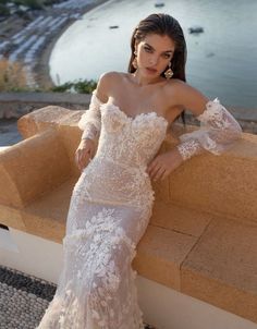 a woman in a wedding dress leaning on a wall