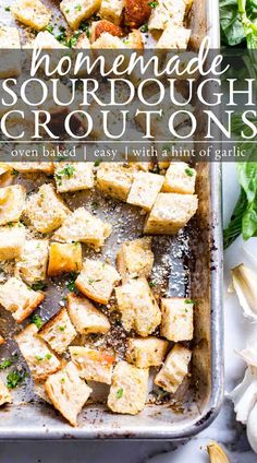 homemade sourdoudough croutons on a baking sheet with herbs and garlic