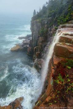 an ocean cliff with waves crashing on the rocks