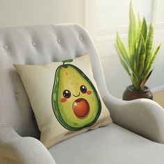 an avocado pillow sitting on top of a chair next to a potted plant