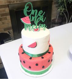 a watermelon themed cake with the words one in a melon on top