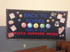 a back to school sign hanging on the wall in a classroom with wooden pews