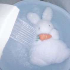 a bathtub filled with water and a stuffed animal in it's head being washed