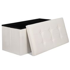 a white leather storage box with black linings on the lid and bottom, is shown