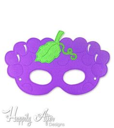 a purple mask with green leaves on it