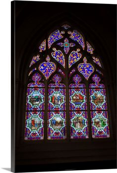 a large stained glass window in a church with multiple colors and designs on it's side