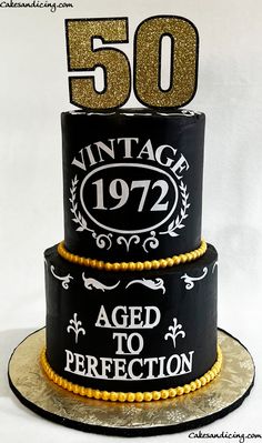 a 50th birthday cake decorated with black and gold icing, featuring an aged to perfection sign