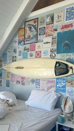 a surfboard mounted to the wall above a bed