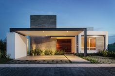 the entrance to a modern home at dusk