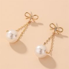 Exquisitely accent your ensembles with these earrings crafted from lustrous metal. Embellished with shimmering cubic zirconia and pearl. 0.51" W x 1.61" L 18k gold-plated copper / cubic zirconia / pearl Chain Drop Earrings, Earring Crafts, Cubic Zirconia, 18k Gold, Gold Tones, Pearl Earrings, Gold Plate, Copper, Plating