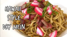 a white bowl filled with noodles and radishes on top of it's side