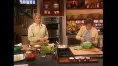 two women are in the kitchen preparing food on a cutting board and chopping vegetables