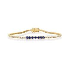 A true classic, our Diamond Four Prong Tennis Bracelet is accented with larger four prong set blue sapphires at the center. Handcrafted in 18-karat yellow gold and set with 1.50 carats of round, brilliant-cut white diamonds this bracelet has timeless appeal - the perfect gift for yourself or someone you love, because diamonds are always a good idea! Bracelet measures 6.5 inches in length Diamond Carat Weight: 1.50 ct Blue Sapphire Carat Weight: 0.53 ct Stone size: 1.5 mm / Accent - 2.5 mm Diamon Luxury Sapphire Tennis Bracelet With Brilliant Cut, Classic Sapphire Diamond Bracelet With Brilliant Cut, Elegant Sapphire Tennis Bracelet With Brilliant Cut, Sapphire Brilliant Cut Diamond Bracelet, Classic Diamond Bracelet With Sapphire, Brilliant Cut Sapphire Diamond Bracelet In Fine Jewelry Style, Sapphire Diamond Bracelet With Brilliant Cut, Classic Sapphire Diamond Tennis Bracelet, Classic Sapphire Diamond Bracelet