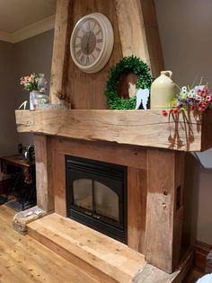 a fireplace with a clock and wreath on top