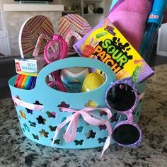 a blue basket filled with lots of toys on top of a counter