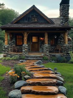 a stone house with steps leading to the front door