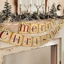 a merry christmas banner hanging from the mantle