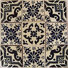 some black and white tiles are arranged in a square pattern on the wall or floor