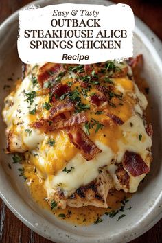 a white plate topped with chicken covered in cheese and bacon next to a small sign that says easy & tasty outback steakhouse alice springs chicken recipe