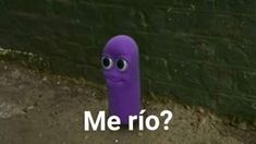 a purple tube with eyes on it sitting in front of a brick wall that says me rio?