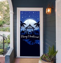 a christmas door cover with the nativity scene on it and palm trees in front