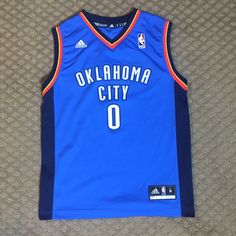 This Russel Westbrook Jersey Is In Perfect Condition! The Logos And Letters Are Not Faded, And Look Brand New. There Are No Rips, Stains, Or Tears. Super Comfy, And Would Be Perfect For An Okc Fan, Or Jersey Collector! Adidas Blue Sleeveless Top, Russel Westbrook, Adidas Blue, Blue Adidas, Be Perfect, Blue Orange, Kids Shirts, Adidas, Brand New