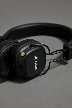 a pair of headphones sitting on top of a gray table next to each other