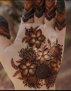 the hand is decorated with flowers and leaves