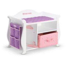 a white toy shelf with pink and purple drawers