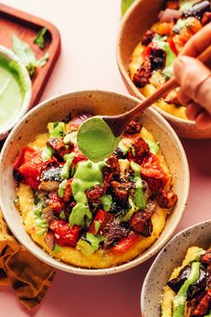 two bowls filled with food on top of a table