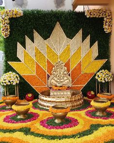 an elaborate floral display in the middle of a room with yellow and red flowers on it