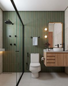 a bathroom with a toilet, sink and shower stall in it's own area