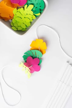 some paper flowers are on a white table