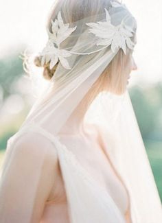 a woman wearing a veil with flowers on it