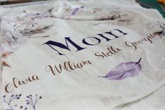 a close up of a sheet of paper with the words mom and two birds on it